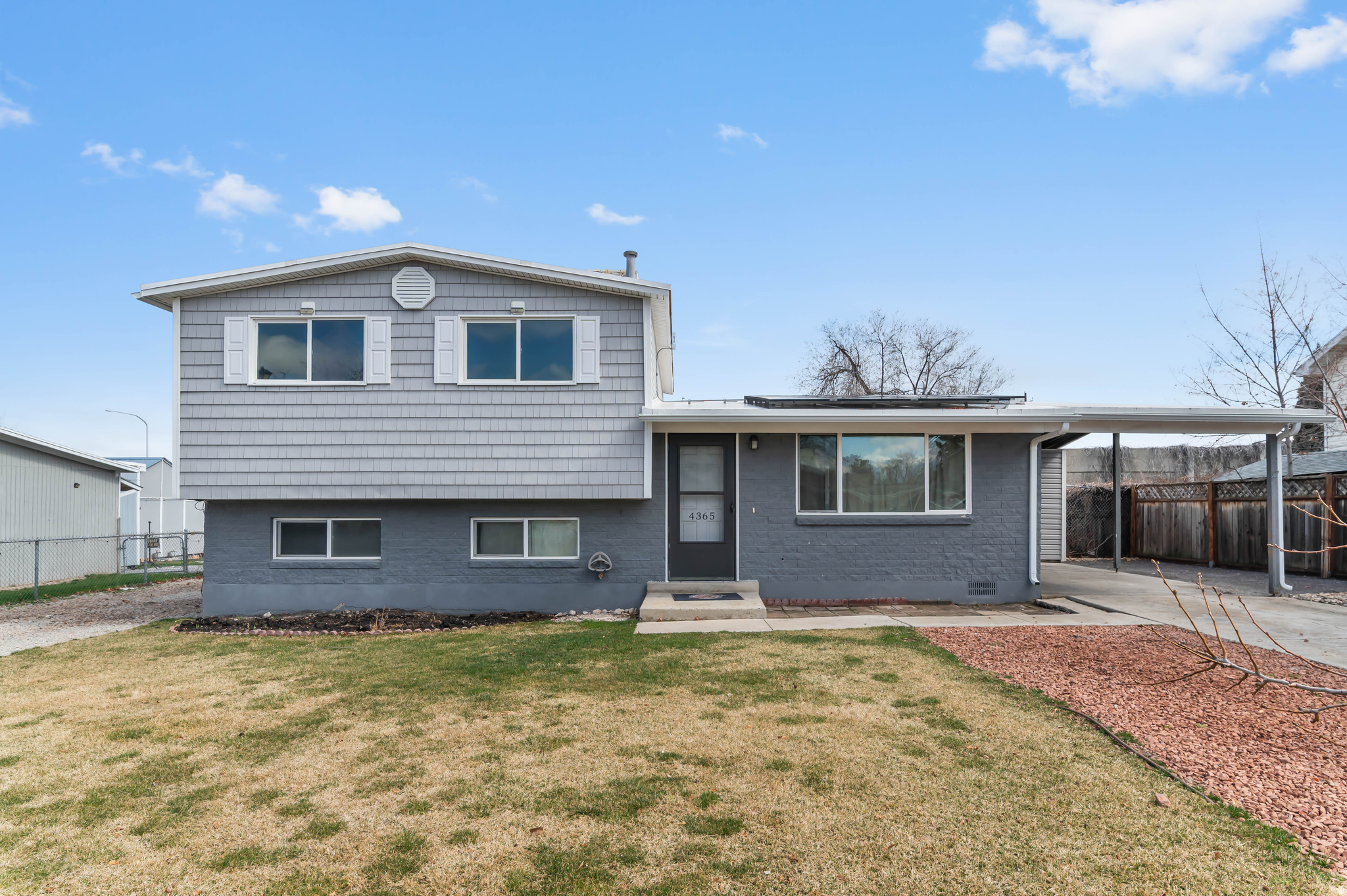 This West Valley tri-level home has a lot to offer across 1,461 square feet, offering 4 bedrooms, 2 bathrooms, and a partially-finished basement. The bright kitchen features white cabinetry, stainless steel appliances, and warm wood-style floors that carry through the main living areas. One of the standout features is the fully owned solar panel system with a backup battery installed in 2022, meaning lower energy bills and peace of mind from day one. The xeriscaped yard keeps maintenance minimal while still providing a comfortable outdoor space. A covered carport and additional RV parking round out the practical extras. Don't miss out on this solid opportunity in a convenient West Valley location close to shopping, dining, and easy freeway access.
