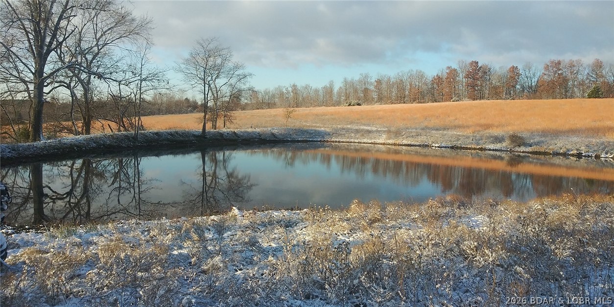 Discover the perfect blend of productivity and recreation on this stunning 80-acre tract located in Ripley county 15 miles west of Doniphan. Bordered on two sides by National Forest, this property offers unmatched privacy and a natural extension for outdoor adventures. The gently rolling pasture is complemented by approximately 20 acres of timber, providing ideal cover for both wildlife and livestock. The land features 5 ponds and a central wet-weather creek that holds water most of the year for reliable fresh water. It is fully perimeter-fenced with additional fencing, and currently leased for cattle grazing. Existing structures include an older garage and small building with great hunting bunkhouse potential. Electric service is on site and with multiple scenic building sites. This is the ultimate canvas for a secluded homestead or cabin with few neighbors, yet you're only a short drive to local dining and shopping. Abundant deer, turkey, and small game thrive here, making it a true hunter's paradise. Whether you seek a working ranch, a recreational retreat, or a future homesite, this rare combination of productive pasture, woods, and water is a premier opportunity. Agent owned.
