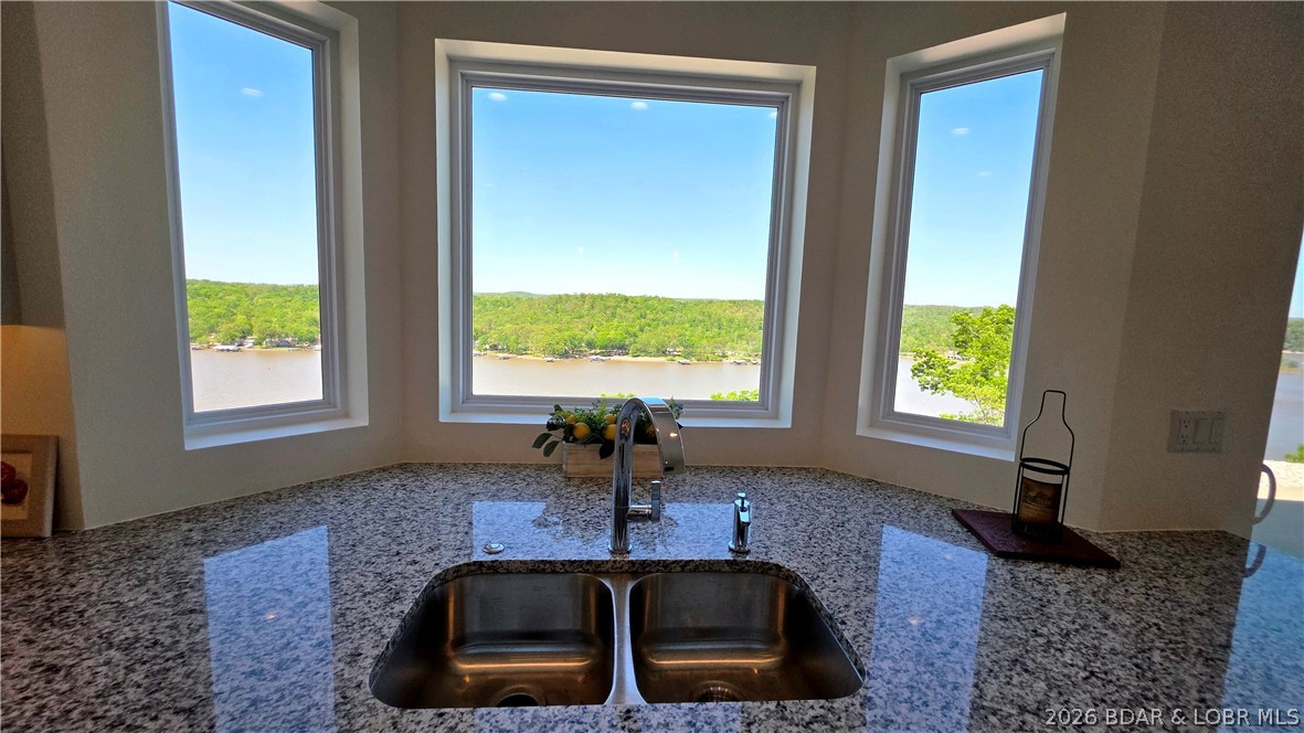 PRICE IMPROVEMENT, SELLER WILL LOOK AT OFFERS! Perched high above the water like a private lookout, this stunning 2022-built lakefront home delivers jaw-dropping views that stretch for miles. From sunrise shimmer to golden-hour glow, every window frames a masterpiece. Designed with comfort and easy living in mind, the spacious layout flows effortlessly, offering both open gathering spaces and cozy retreats. Home offers so many extras, heated floors, granite countertops, tons of storage in the home and the garage as well as the whole house generator to prevent power outage issues. Step outside and let the day melt away in your private hot tub or unwind in the sauna after a day on the water. Adventure is always within reach with the nearby Wigwam Conservation boat launch and fishing dock, making it simple to spend your days cruising, casting, or just soaking up lake life. Whether you're seeking a peaceful escape or the perfect place to entertain, this cliffside gem delivers the views, the vibe, and the Lifestyle all in one unforgettable package.
