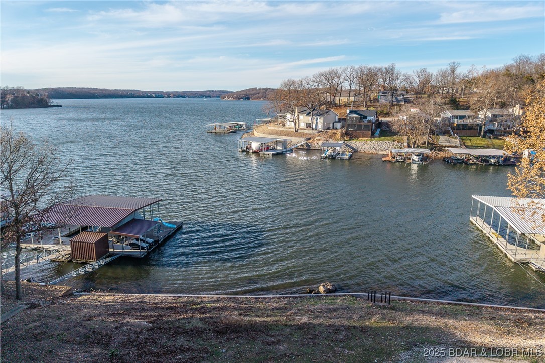 Rare Double Lakefront Lot in Highly Desirable Linn Creek Cove! Opportunities like this don’t come around often! This exceptional double lakefront lot offers 137 feet of pristine waterfront in a deep-water cove with excellent protection—while still capturing beautiful main channel views of the Four Corners. The perfect combination of privacy, scenery, and premium lake access. All the hard work has already been done for you. This property includes: New seawall and riprap for long-term shoreline security,  engineered septic system configuration, current survey, house plans and dock plans already completed with room for a large dock thanks to generous water frontage and deep water. Whether you’re envisioning a luxury retreat or a full-time lakefront dream home, this rare offering provides a true “build-ready” experience in one of the most sought-after areas at Lake of the Ozarks. Bring your builder and start making your lake life vision a reality!