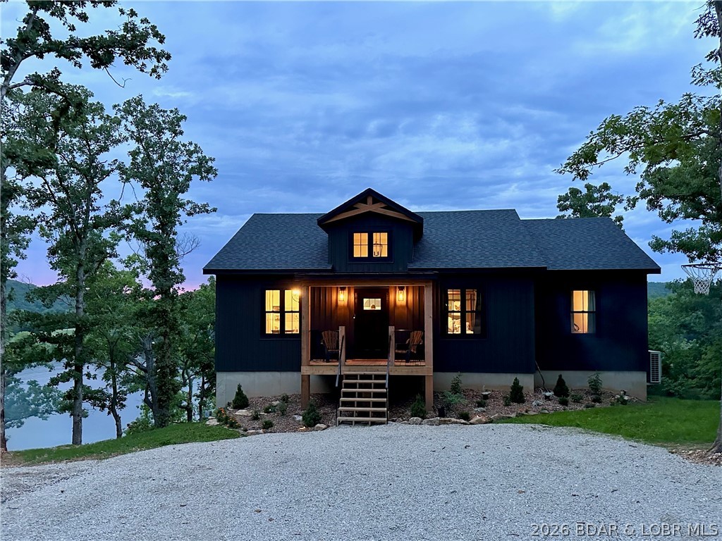 Newly built in 2024, breathtaking views, BEAUTIFUL sunsets, this is your lake dream! Being sold TURN KEY with all furnishings, this home has it all! With a strong rental season its first year ($50,000), AirDNA is projecting $105,800 this year! Already $29,000 in bookings for the upcoming season. Perfect for investors and large families alike. Home is so welcoming and accommodates up to 30 guests with 18 beds currently. (7th bedroom is non-conforming). Room for everyone in this open concept beauty. You will love the well appointed Chef's kitchen complete with 8 burner stove! Family room is complete with a kitchenette on the lower level. This peaceful cove at the 44 mile marker of the Osage is perfect for boating, fishing & swimming. Two well dock with swim platform and boat lift included. Lovely wooded areas throughout the neighborhood add an element of privacy too. Fiber internet, community well and community septic are just icing on the cake. Built with quality and efficiency in mind, the low utility bill will impress! The pictures are beautiful but don't do it justice, come see for yourself. The Lake of the Ozarks is your playground!