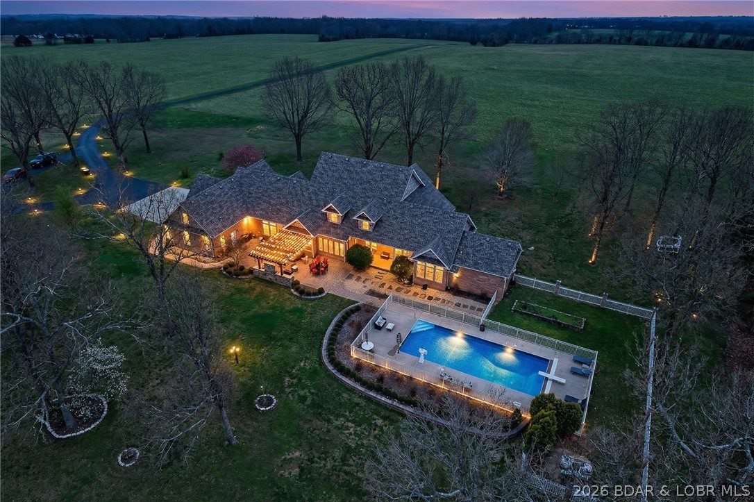This stunning, country estate sits on 5 beautiful acres with panoramic views for days. The massive home features over 6,400 finished sf, 10’ ceilings, geothermal heating & cooling, 6 beds (4 with walk-in closets & private baths), & 5 full & 2 half baths. Beautifully refinished hardwoods, gas fireplace, sunroom & built-ins are extras you’ll love. The master suite checks ALL the boxes, including double sinks, soaker tub & 2 massive walk-ins w/ luxury organizing systems. The spacious upper level offers 3 bed, 2 full baths, & walk-in attic storage. The finished basement allows you to entertain a crowd, including a wet bar, guest bedroom, bath, & ample storage. The back patio is where the real magic happens, featuring a well-equipped outdoor kitchen, pergola, & heated in-ground pool w/ 9’ deep end & auto safety cover. 3-car garage w/ separate workshop space & full bath. Brand-new roof, Anderson windows, invisible pet fence, in-ground sprinklers & deluxe security system are bonuses you’re sure to value! This layout would work very well for multi-gen living as well. THIS is luxury living in a rural setting; the kind of DREAM HOME you don’t often find. Schedule your private viewing today.