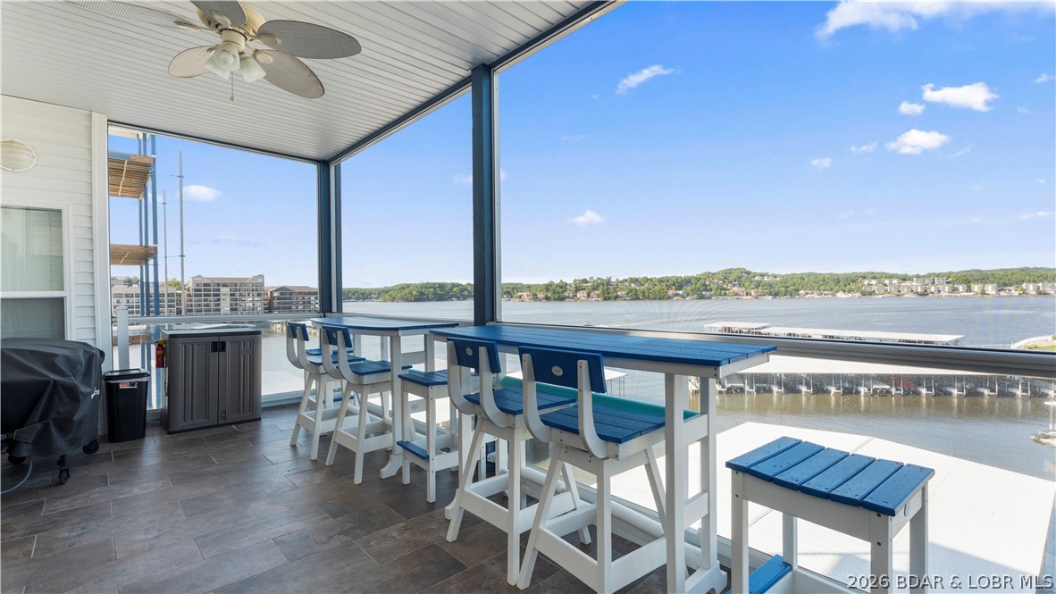 This exceptional 3-bedroom, 2.5-bath fully furnished lakefront condo offers the ultimate "turn-key" Lake of the Ozarks experience. Positioned as the original "model" unit, it boasts superior details and numerous upgrades, including crown molding with accent lighting, stainless steel appliances, and granite countertops. Some of the key condo features are elevator access that opens directly in front of  the unit. Open-concept living, dining, and kitchen area with tasteful, included furnishings. Screened-in lakeside patio equipped with high-quality matching Polywood furniture. A cozy fireplace designed with plumbing capabilities to allow an outdoor spigot for grilling. Access to three community pools. Includes a 12' x 36' boat slip. Conveniently located at the 2mm, providing quick access to restaurants, golf, and shopping. Complete your lake lifestyle with the optional, separate purchase of the seller's boat and hoist: 2015 Bennington Tritoon 25R, 250HP Mercury Outboard with only 415 hours, 10,000 lb capacity hoist already installed in the slip. This is a rare opportunity to purchase a meticulously maintained, model-level unit with top-tier amenities at the Midwest Coast.