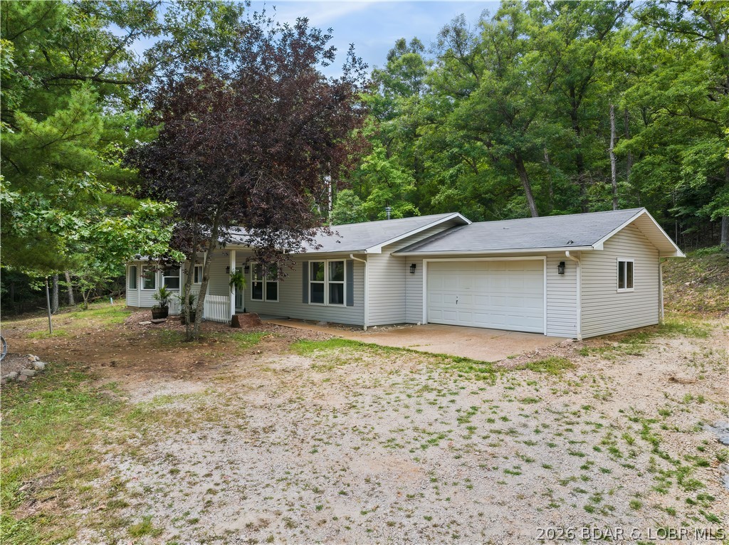 Country Living has a one level Ranch Home on 1 Acre that has been recently updated and has new Laminate Flooring.  Nice covered Porch goes into the open Living/Kitchen/Dining rooms.  The Living Room has a Wood Insert Fireplace and new Beam Ceilings.  The Kitchen has a Work Island with a Breakfast Bar, lots of Cabinets and a Dining Room with a nice Bay Window.  There is also a Sunroom off the Kitchen.  The main Bathroom is totally remodeled with a large Walk-In Shower.  There is an attached 2-Car Garage and Storage Shed.  This home is close to Ha Ha Tonka State Park that has the Castle, a public Boat Ramp, Picnic area and Walking Trails.  Great Country location.