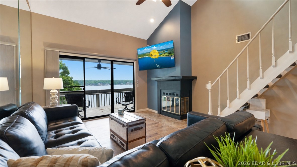 IDEAL location by land AND water! Situated right next to Margaritaville, this top-floor 3-bedroom, 2-bath condo at Pelican Bay Condos offers the complete lake package; and nightly rentals are allowed! Perfectly positioned in a protected cove while still capturing stunning main channel views of the Osage 26MM, where you'll enjoy watching countless boats cruise by & taking in breathtaking sunsets from your private deck. This move-in ready, FULLY furnished unit includes a 12' x 36' boat slip (Dock H, Slip 4) just steps away & visible from the deck! Inside you'll find vaulted ceilings with a decorative beam, updated HVAC (2022), SS  appliances, fresh paint & a blend of tile/LVP flooring throughout. 2 spacious bedrooms are located on the main level, plus a large third bedroom upstairs. The loft comfortably sleeps four with a queen bed & built-in bunks; perfect for family & guests. The fireplace creates a warm focal point without sacrificing lake views. Located directly across from the pool/clubhouse with ample parking. Surrounded by popular waterfront restaurants, entertainment, shopping, grocery stores & convenient highway access, this TURNKEY retreat is ready to enjoy from day one!