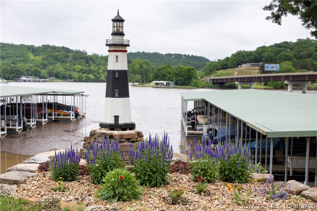 Sitting on a bluff over the majestic Big Niangua, The Lighthouse Condo is your beacon to lake enjoyment. This wonderful condo includes a 10x24 boat slip (with Dock Box) and an available garage as well, making it the perfect setup for full-time living, weekend escapes, or vacation rental potential at the Lake of the Ozarks. Inside, the open-concept kitchen, dining, and living areas create a welcoming space designed to maximize comfort and lake views. The living room features an electric fireplace, while large windows and patio access showcase the stunning scenery outside. The kitchen offers tile flooring, bar seating, and a white appliance package including Whirlpool oven and microwave.

The spacious primary suite opens directly to the patio and features a large walk-in closet, dual sinks, and private bath. Guests will appreciate the second bedroom with adjoining bath access and walk-in shower.

The real star of the show is the elevated bluff-top setting overlooking the Big Niangua arm of the lake. Whether enjoying sunrise views from the patio, evenings by the fireplace, or weekends on the water, this condo delivers the classic lake lifestyle people come to the Ozarks to find.