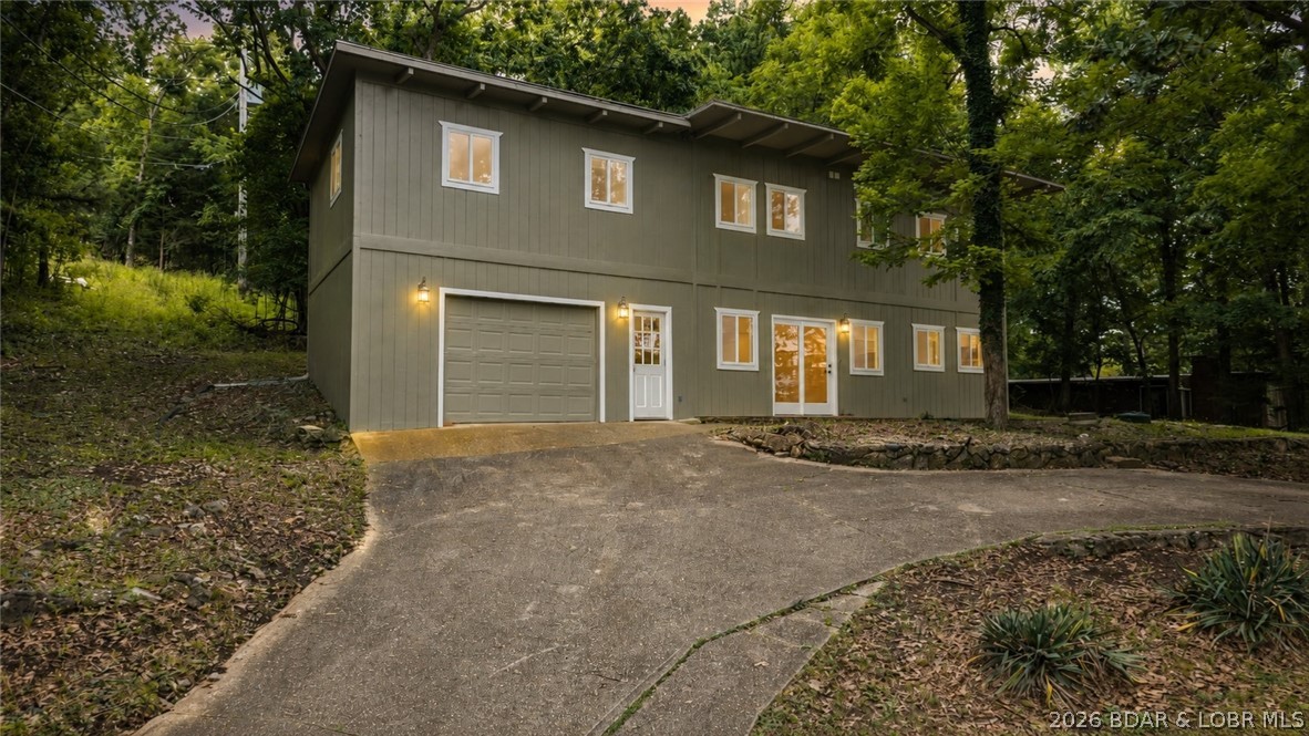 Welcome to 338 Crane Cove — a stunning, fully remodeled Lake of the Ozarks retreat where modern luxury meets effortless lake living. Completely transformed in 2025, this home was taken down to the studs and rebuilt with all-new flooring, HVAC, plumbing, electrical, sheetrock, and custom finishes throughout, giving you the peace of mind of new construction at a fraction of the cost.
Nestled in the coveted Crane Cove community at the heart of the 10 Mile Marker, this 3-bedroom, 3-bathroom home offers over 2,000 finished square feet across two thoughtfully designed levels. The main floor features a stunning custom kitchen, spacious living and dining areas, and an oversized garage. Upstairs, a luxurious primary suite with walk-in shower and closet, two guest bedrooms, a full bath, laundry, and a bonus game room await. Best of all? Your private 10x24 boat slip is just steps from your front door — no hauling, no hassle, just pure lake life on demand. Whether you're envisioning a full-time residence, a weekend getaway, or a thriving vacation rental, this property offers endless potential in one of the lake's most sought-after locations. Don't just dream the lake life — live it.