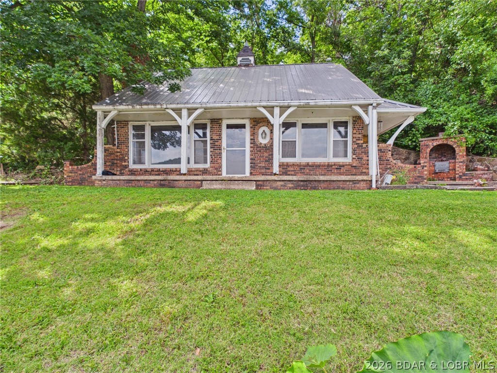 Attention flippers, investors and those just wanting a little piece of Lake of the Ozarks! This FIXER UPPER 2 bed 1 bath cabin situated on over an acre with 115 ft of lakefront has 1036 sq ft of living space along with a 10x20 shop/storage area all overlooking the 5mm of the Little Niangua arm on the Quiet Side of the Lake. With spectacular fishing, low boat traffic and incredible views, this property has unlimited potential for a weekend getaway, simple lakefront living, or a lucrative Short Term Rental. The home still has the charm and good bones of a 1969 build, but is definitely a fixer-upper and is a blank slate for those who may see a modern take on a timeless classic cabin. The spacious dock has a sturdy boat lift in one slip that current holds a 1988 Chaparral 28' boat(included), and a manual PWC lift in the other partially filled in slip, with a seating area and plenty of space for lounging, fishing, or enjoying a dip in the lake. Classic cabins like this are getting harder to find, and with the generous land area and dock envelope, the possibilities are endless.  *** Under Contingent Contract with 72 hour Kickout Clause, Seller is accepting Backup Offers! ***