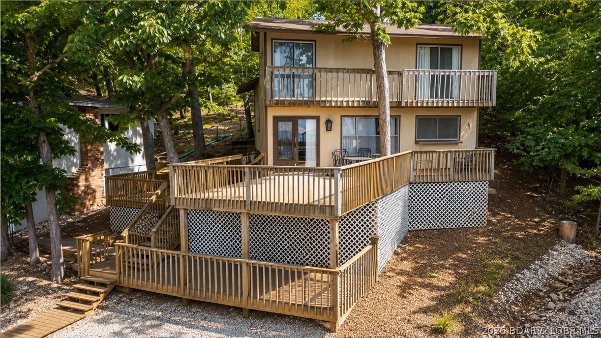 Discover the opportunity to own an affordable lakefront property in the heart of the Gravois Arm at the Lake of the Ozarks. Situated on 50' of shoreline in a protected cove at the 5MM, this 3 bedroom, 2 bathroom home offers 1,271 square feet and endless possibilities for the next owner. Whether you're searching for a weekend retreat, investment property, nightly rental opportunity, or a lakefront fixer upper to make your own, this property is packed with potential. One of the standout features is the massive lakeside deck, providing an incredible space for entertaining, grilling, or simply relaxing while taking in the peaceful cove views. Surrounded by mature trees and tucked away from the hustle and bustle, the property offers a level of privacy that's becoming increasingly difficult to find on the lake. The home comes furnished and includes a private dock with a 10x24 slip, making it easy to start enjoying lake life immediately while you update and personalize the property over time. Bring your ideas and vision and transform this hidden gem into the perfect Lake of the Ozarks getaway you've always wanted.