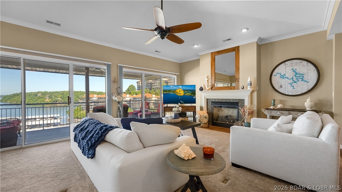 Top-floor lakefront condo at Palisades with the kind of main-channel view buyers hope to find at Lake of the Ozarks. This recently updated 3 bedroom, 3 bath condo in Lake Ozark sits above the 14 mile marker with a covered deck overlooking the main channel, perfect for sunsets, boat watching, and summer fireworks. The included 12x32 boat slip is right in front of the unit, so you can see your boat from the condo and be on the water in minutes. Inside, vaulted and coffered ceilings along with crown molding make the living area feel open and bright.  New furnishings give the entire condo a clean, current feel. Recent updates include the dishwasher, wine fridge, water heater, shower in the guest bathroom, outdoor ceiling fan, and carpeting throughout the unit. Most updates are less than a year old, making this an easy turnkey option with real value already in place. Palisades offers three beautiful pools, clubhouse, gated entry, and a prime location close to dining, shopping, entertainment, and lakefront hot spots by land or water.