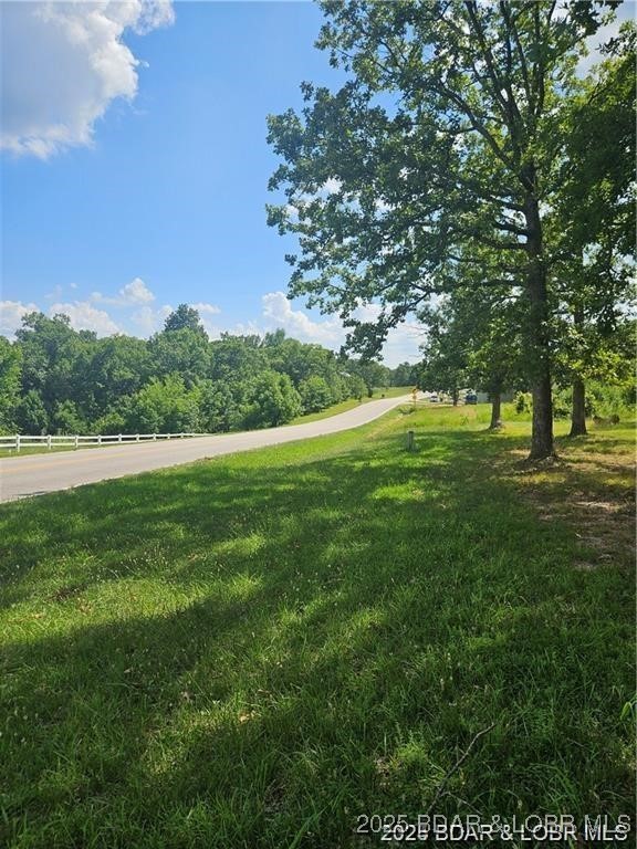 Premium Highway O frontage with city sewer and water available. Located in city limits of Laurie. Not many vacant tracts of land left in Laurie. Great opportunity for the savvy business owner to start something on the booming westside of the lake. Home on property will not convey with property and will be surveyed out before closing.