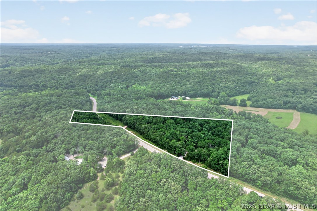 Private 5.82-Acres, Tucked away just off blacktop, this one-of-a-kind property is ready for your next adventure. Beautifully crafted home with quality finishes, custom cabinets, jetted tub, gas range, plus a new well, septic, 2 mini-splits.  Property includes 2 RV pads with full hookups, 2 steel storage containers, greenhouse, garden areas, STYLISH She Shed with heat/AC, bird coop, firepit, young magnolia, peach and elderberry trees, small shop/tool shed,& ROOM TO BUILD!!! Whether you're looking for a full-time residence, weekend getaway, homestead, hobby farm or investment opportunity, this turnkey property offers privacy, functionality, and endless possibilities. All just minutes from the Lake of the Ozarks, Coffman Beach boat ramp, shopping & restaurants.