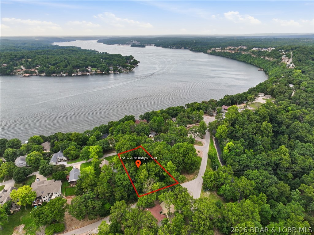 Build your dream home in the desirable Robyn Point Subdivision in Osage Beach! This approximately 0.459-acre lot is nestled on a quiet cul-de-sac and offers a gentle slope that's ideal for building. Enjoy seasonal lake views with lake access at the 28 Mile Marker, along with excellent community amenities including a covered community dock and swimming pool. Water, sewer, and high-speed internet are available, making it even easier to start building your ideal lake home. Whether you're looking for a full-time residence or a vacation retreat, this property offers the perfect combination of privacy, convenience, and lake lifestyle. Located just minutes from shopping, dining, entertainment, golf, and all that Lake of the Ozarks has to offer, this is a fantastic opportunity to own a piece of the lake. Don't miss your chance to make your lake living dreams a reality!