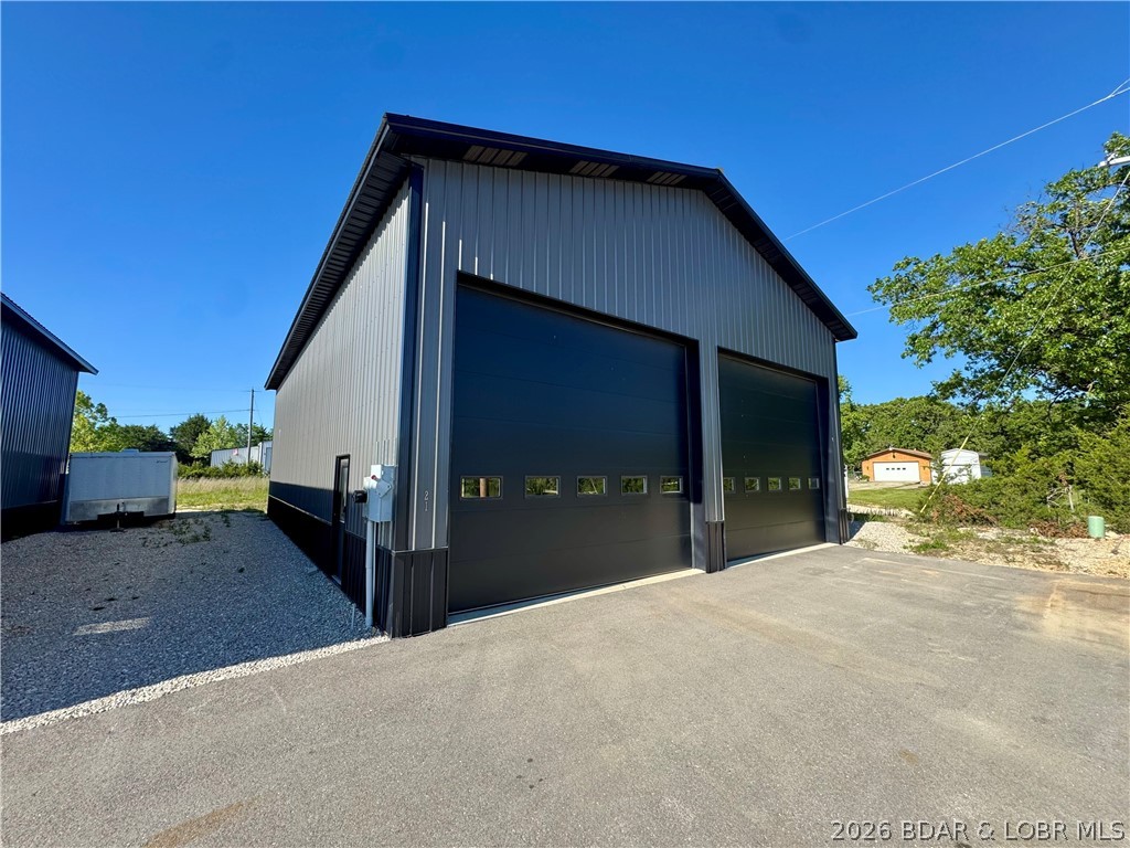 Located just outside the Osage Beach city limits in Kaiser, this versatile 38x60 warehouse/shop offers an incredible opportunity for business owners, investors, contractors, hobbyists, or anyone in need of functional storage and workspace near the heart of the Lake of the Ozarks. Featuring 18-foot ceilings, two oversized garage doors, three-phase electric, and plumbing already ran to the building for a future bathroom, this insulated shell is the perfect blank canvas to customize for your specific needs.

Positioned at the end of a three-unit setup, the property offers ample parking both in front and around the building, ideal for equipment, trailers, work vehicles, or easy customer access. Whether you're looking for a warehouse, workshop, mechanic shop, boat storage, contractor headquarters, investment property, or personal garage space, the possibilities here are endless.

Conveniently located just about one mile outside Osage Beach city limits, you get easy access to town while enjoying flexibility and functionality that’s hard to find in the area.