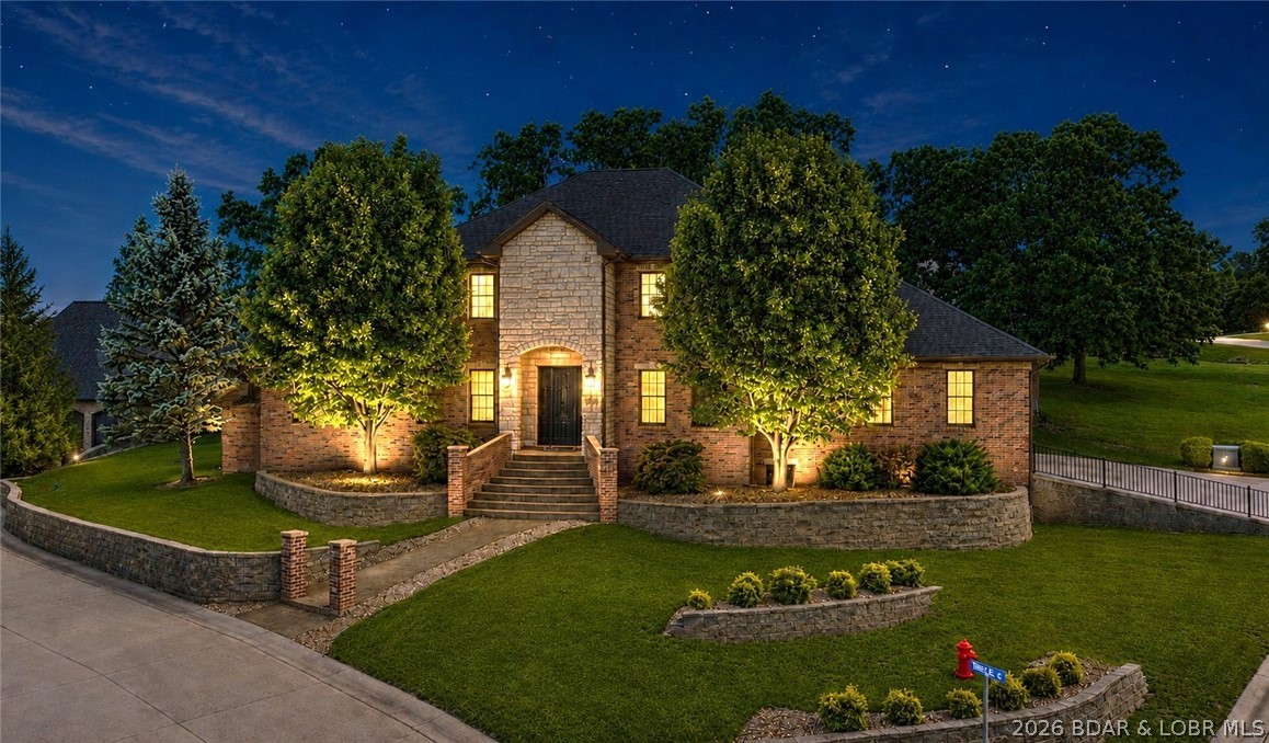 Exceptional custom-built home offering nearly 6,000 sq ft of primarily main-level living within the sought-after gated community of Woodland Cove. This impeccably maintained 5-bed, 4.5-bath residence is located in the Camdenton School District, just 2 miles from Lake Regional Hospital. Enjoy lake access with community boat ramp, 12x28' boat slip & PWC space walking distance away. Exterior features include all-brick construction w/ cement board siding, 3-car garage, newer roof (2023), recently painted interior, irrigation system, resealed stamped concrete driveway, private patio w/ hot tub box & cul-de-sac location, offering extra parking & ideal bike riding! Inside offers 3 separate living areas, workout or media room (pre-wired), 10’ ceilings with soaring 20’ vaulted spaces, tornado/wine room & abundance of storage. Spacious kitchen features custom cabinetry, granite countertops, large pantry & accent lighting. Luxurious primary suite includes huge dual walk-in closets, tile shower & soaking tub. Minutes from shopping, dining & top Lake attractions. Some AI generated images for updates in the back yard and inside, to give you an idea, if desired. Well loved & move-in ready!