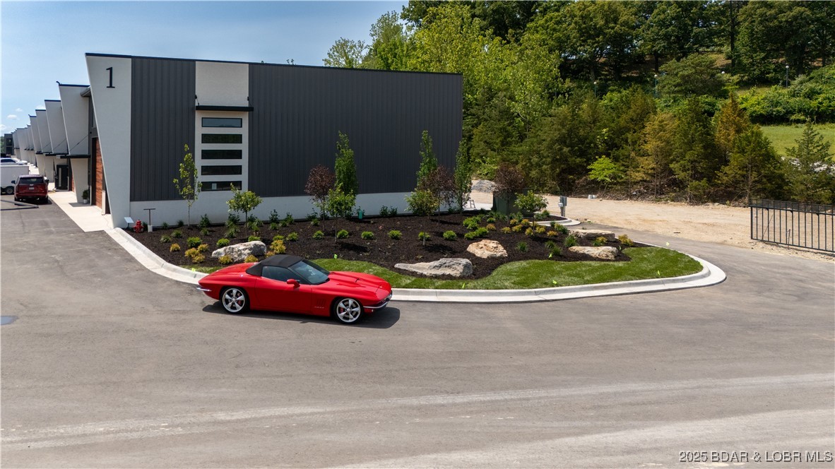 The Toy Box is located at the Lake of the Ozarks most recognized intersection at Horseshoe Bend and Bagnell Dam Blvd. in Lake Ozark, Missouri. With a 180 degree Panoramic View of Lake of the Ozarks, these Lux Loft units are like nothing else in the area. This unit is (25’ x 60’ with 23’ side walls and a mezzanine) for Residential use only. The development will be governed by a Condo Owner Association and offers  a pool, clubhouse with full indoor kitchen, innovative gym, pickle-ball court, basketball court, A boat wash area and RV pump out allow you to work and play within your own community. An observation deck overlooking miles of Lake of the Ozarks shoreline truly set this property apart from all others, while giving you the peace of mind of a gated community! All of this just a minute drive from the buzzing Bagnell Dam Strip. Come be a part of the Lake of the Ozarks where We Have a Lifestyle For You!