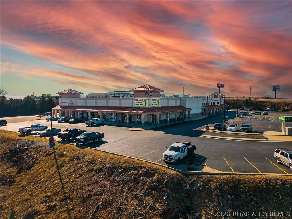 Excellent opportunity to lease an office/retail space with excellent Hwy exposure to Hwy MM- and Hwy 242 and off Bus 54.  High Traffic counts being next to established businesses and retail and in the Woods Shopping Center Plaza. This space offers several options with an office/reception area, storage and bathroom.  Easy access to all the amenties of Lake Ozark and Osage Beach with potential clients coming from HH and Porto Cima and The Vilages. Please call for more details in regards to terms and possible finish with owner.