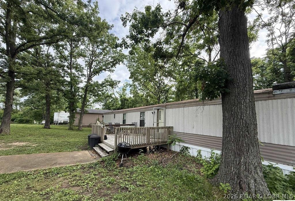 3 bed, 2 bath home situated on 4.71± acres in a great location near multiple Truman Lake boat ramps. This property offers both a well hookup and electric already in place. Conveniently located just off a state-maintained highway for easy year-round access. Enjoy access to a private lake along with the peace and privacy of acreage living. Detached 1 car garage.