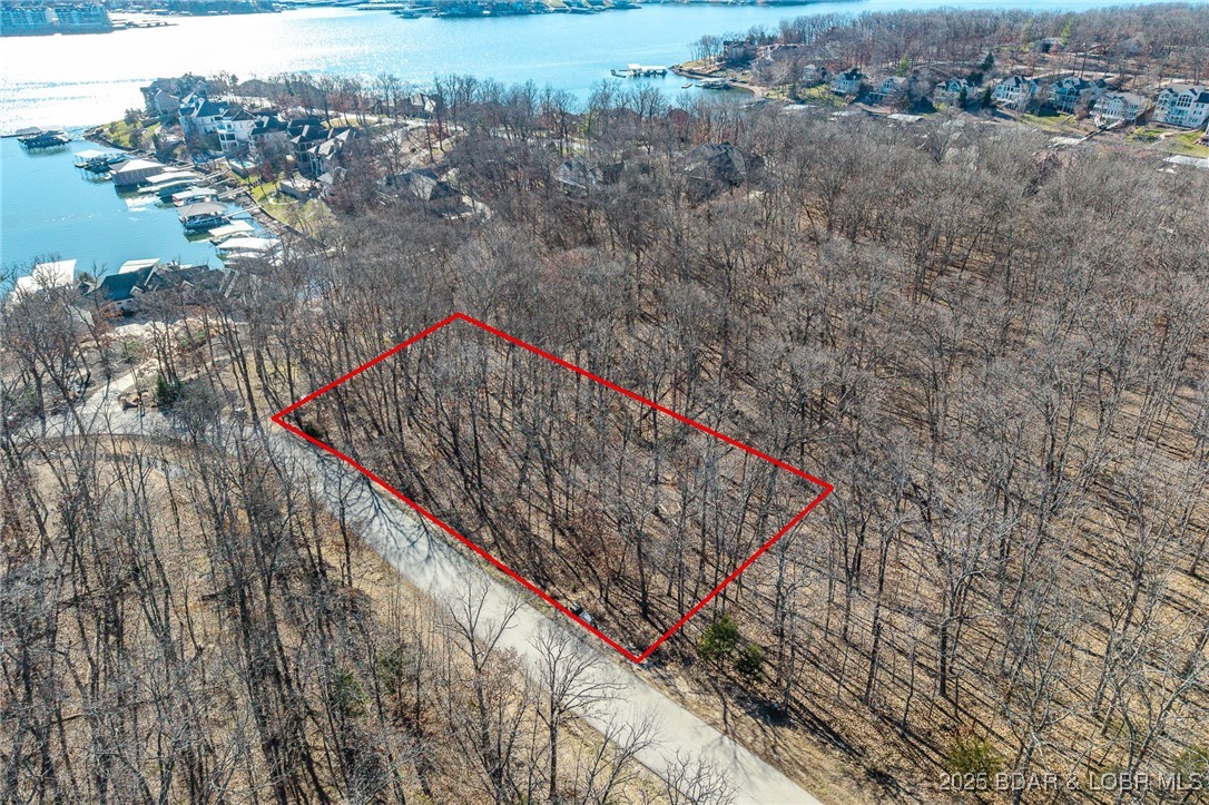 This Lakeview lot at The Villages at Shawnee Bend offers scenic views of the Lake of the Ozarks paired with the amenities of a premier master-planned community. Enter through the striking grand waterfall entrance and experience a neighborhood designed for both relaxation and recreation. Homeowners enjoy a welcoming clubhouse, multiple community pool, championship tennis courts, and pickleball facilities, as well as parks, and playgrounds. With paved roads and underground utilities in place, this lot is ready for a thoughtfully designed home that captures the lake views while embracing a vibrant, resort-style atmosphere.