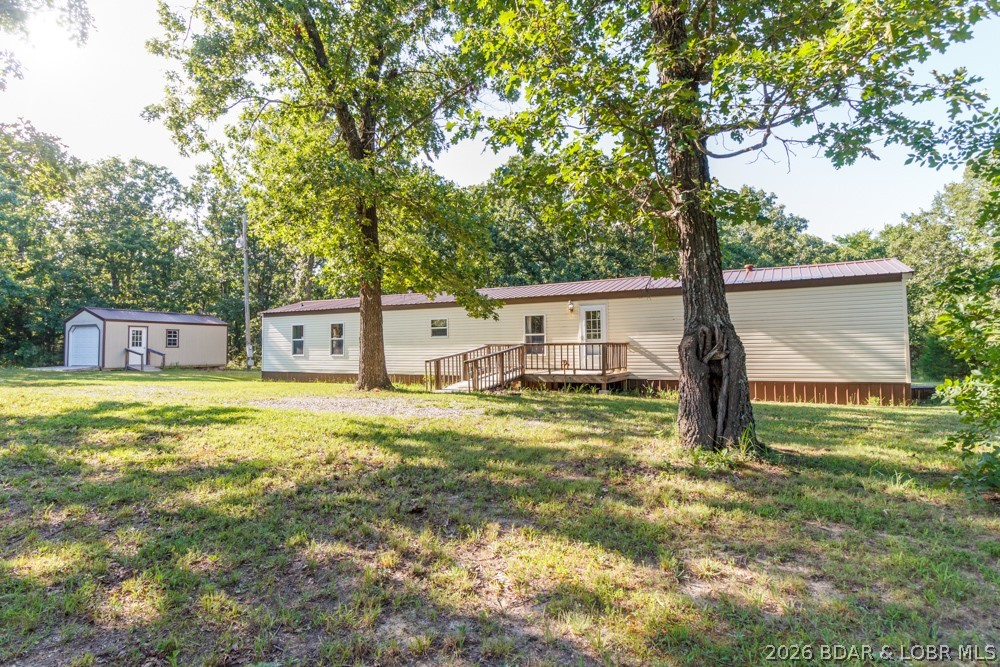 Enjoy peaceful country living with this all electric single-wide home situated on 3.30 acres! Offering over 1,200 sq ft of living space, this 3 bed, 2 bath home provides room to spread out while enjoying the privacy & beauty of nature.
Inside, you'll find a comfortable layout featuring a combination of hard wood & newer carpet flooring. Step outside onto the back deck, the perfect place to relax, entertain, or watch the wildlife that frequents the property. Both the front & back entrances are equipped with accessibility ramps for added convenience. The property includes county water, a lagoon, & a versatile portable building with electricity & a garage door ideal for storing equipment, a small vehicle, ATVs, or creating your own workshop or hobby space. Major updates include a durable metal roof installed approximately 3 years ago, along with a newer furnace and water heater, providing peace of mind for the next owner. Previously used as a long term rental, this property offers excellent potential as a primary residence, investment property, or weekend getaway. Don't miss this opportunity to own acreage with room to enjoy the outdoors while remaining just a short drive from town!