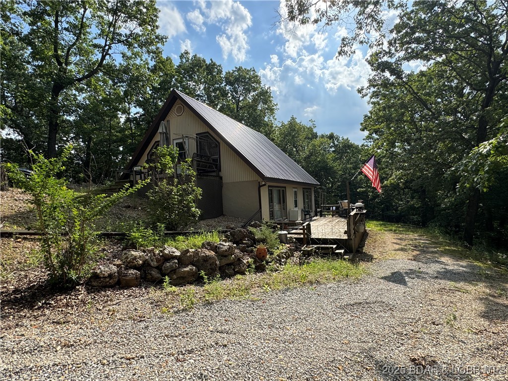 ZERO RESTRICTIONS! Charming cottage on 37.5 Acres very close to everything at the Lake! This is a great location just down Hwy 7 in Greenview you are nearby places to eat 15 mins or less to  Tres Hombres, Stogies Tavern and O'Tommys or the Nautifish! If you are looking for the perfect getaway to escape and enjoy the wildlife, keep as a hunting retreat or live full-time life look no further. This cozy 2 bedroom and 2 bath has a kitchen with gas stove and Samsung refrigerator, very large walk-in pantry and plenty of cabinets and counter space! Upper and lower living areas and multiple decks means this place has lots to offer in a private and peaceful setting with only 5 mins (one mile) of gravel!  It sits on 37.5 acres, has a 30x50 shop with metal insulated roof, comes fully furnished and move in ready plus a new roof was just put on the house this year. This property offers great hunting and has lots of wildlife. Maybe thinking about boating at Lake of the Ozarks? Larry Gale access is a large 2 lane concrete public boat launch for any size boat, it's only 7 miles away! Own a piece of Gods green earth, land is always a great investment - they are not making any more of it!