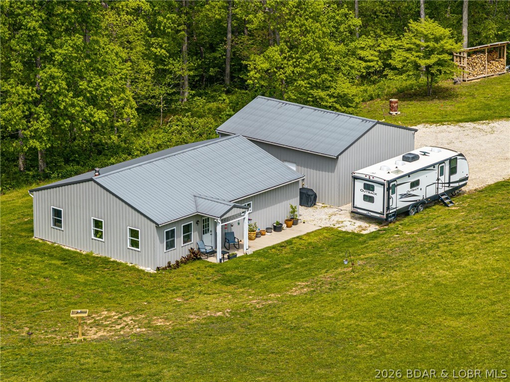 Wonderful 2 bdrm 1 bath home that sits in a quiet setting on a 24-acre tract of mostly timbered land with a few acres of open pasture\grassland. This all-electric home has a kitchen with granite countertops and a butcher block island-countertop with high-top stools. Spacious bathroom with a jacuzzi tub and a walk-in tiled shower. Wood-stove in living room that keeps you cozy in the winter and your electric bills low!! Outside you will enjoy the raised gardens, several trails on the property perfect for afternoon walks or jump on the ATV and head to the creek where a picnic area & firepit is already in place. A 2-car detached garage with concrete floors, recently insulated and drywalled, updated electrical with 100amp service and lots of added shelving. 50amp service on side of garage for guests with campers! Lots of wildlife on the property. Amazing fiber internet service, great for those that want to work from home! No restrictions, no HOA. Paved roads all the way to driveway! In a great location; Just 10 minutes to BuckNaked Restaurant and Marina, 20 minutes to Cole Camp or30 minutes to Warsaw!! Lots to see and do on this property!! Don't miss out!