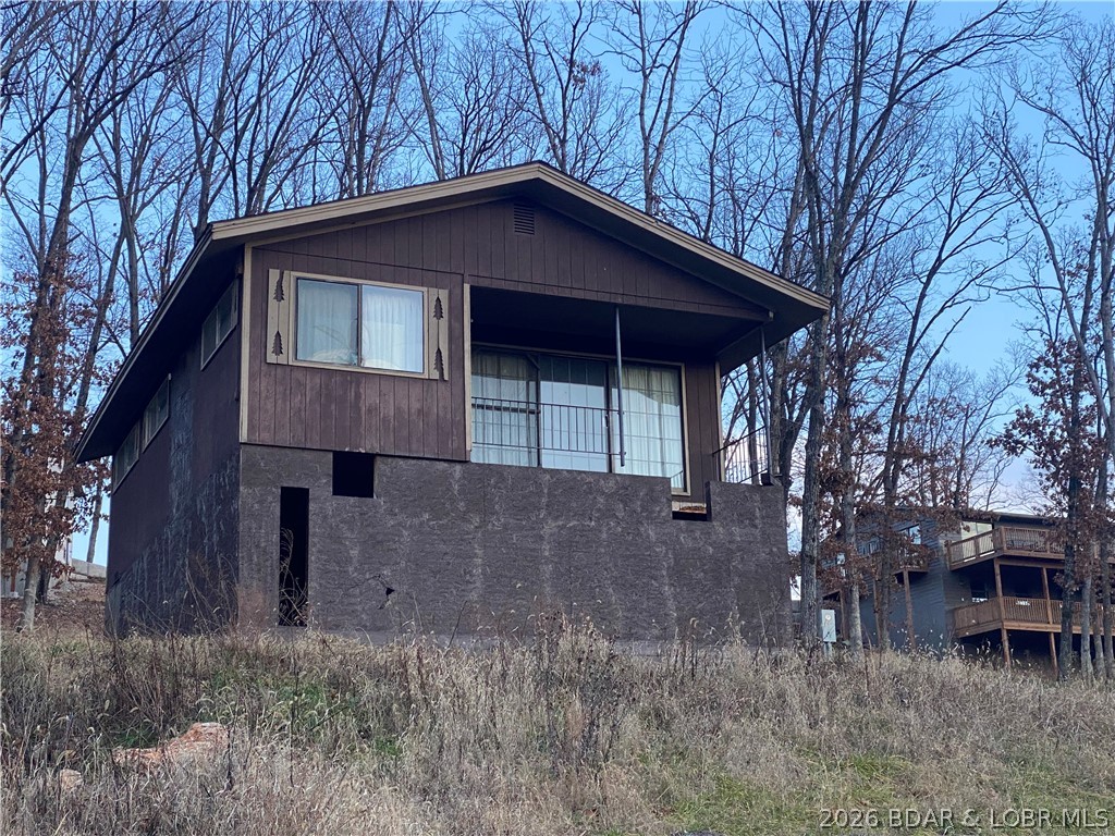 Unique opportunity for a Fixer Upper. Turn this home into your own Lake escape, full time residence, Air BnB, or just fix and flip.  Home is finished, and furnished, on the upper level, sitting on a new unfinished walk-out basement that can be finished to your specs. Currently a 3 bedroom 2 bath. Full kitchen, dining area, and living room. All utilities are run to the home and just need hooked up. Hook-up the utilities and you could live in the home while doing your renovations. Home is being sold as-is.