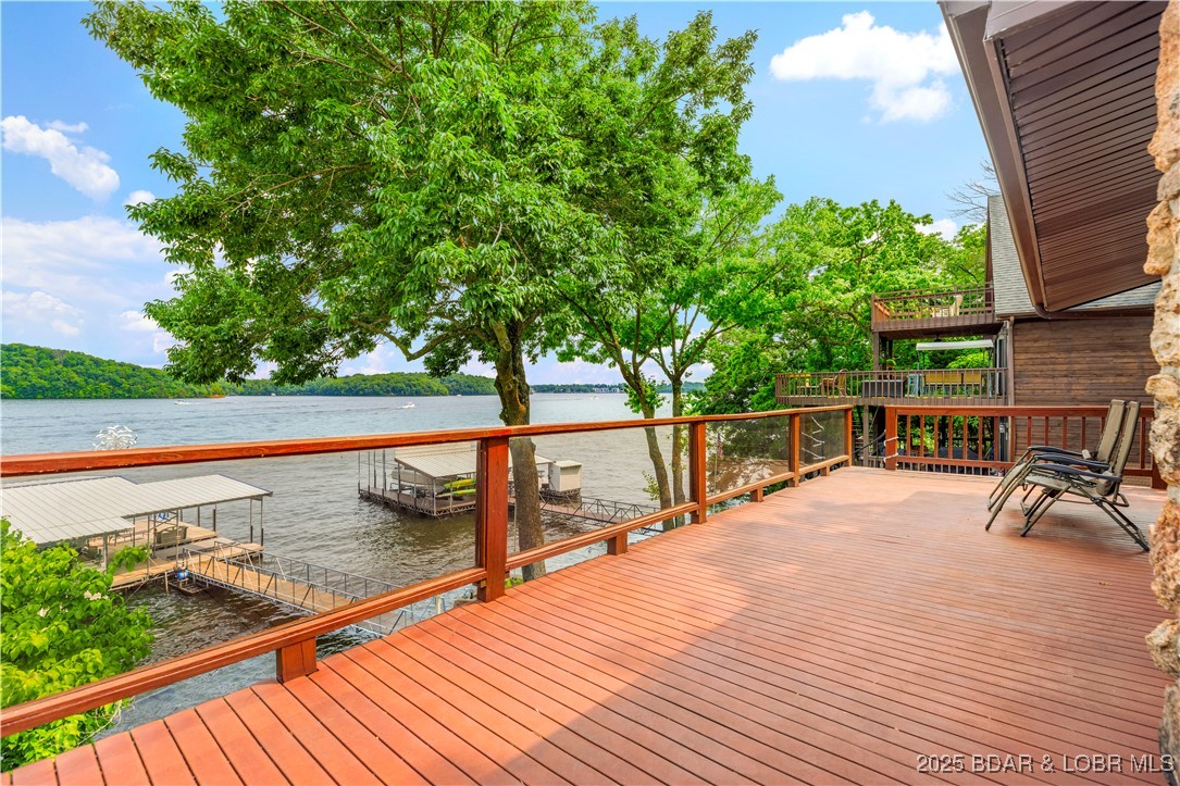 Welcome to your dream lakefront retreat in the Lake of the Ozarks— Nestled on the desirable 2nd mile marker in the Gravois Arm, this beautifully updated (2023) 4-bedroom, 3-bath home offers million-dollar views and over 100 feet of pristine lakefront. (Fourth bedroom is non conforming.) With 2,430 sq ft of thoughtfully designed living space, you’ll enjoy stone fireplaces on both levels, a large carport, and a two-car garage with abundant storage. Seamless indoor-outdoor living awaits with an outdoor kitchen, private concrete boat ramp. Wake up in the master suite to breathtaking views and step right out to a hot tub overlooking the water—perfect for morning coffee or evening stargazing. This is a rare opportunity to own a turnkey slice of paradise conveniently located a short boat ride away to Jolly Rodgers, Dock Knockers, and more .  Schedule your private showing today and start living the lake life you’ve been dreaming of!