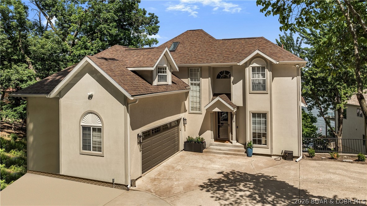 If you've been dreaming of lakefront living, welcome to 18 Valencia Drive at the coveted 11 Mile Marker of Lake of the Ozarks. This beautifully remodeled waterfront home offers panoramic views and more than 3,600 square feet of living space designed for entertaining, relaxing, and creating lasting memories. The custom chef's kitchen features soft-close maple cabinetry, quartz countertops, a marble backsplash, premium tile flooring, floating shelves, under-cabinet lighting, and a stainless gas range. With 6 bedrooms, 3.5 bathrooms, multiple living areas and two family rooms, there's space for everyone. The primary suite includes a remodeled bath with a tiled walk-in shower and double vanity. Outdoor living shines with new composite decks, a screened porch, and spectacular lake views. The private dock offers two boat slips, a swim platform, upgraded electrical, and Bluetooth speakers. Additional upgrades include high-efficiency HVAC systems, water softener and RO systems, irrigation, landscaping, and mechanical improvements. Combining luxury updates, waterfront amenities, and an exceptional location, this Lake of the Ozarks retreat is the perfect place to enjoy the lake lifestyle.