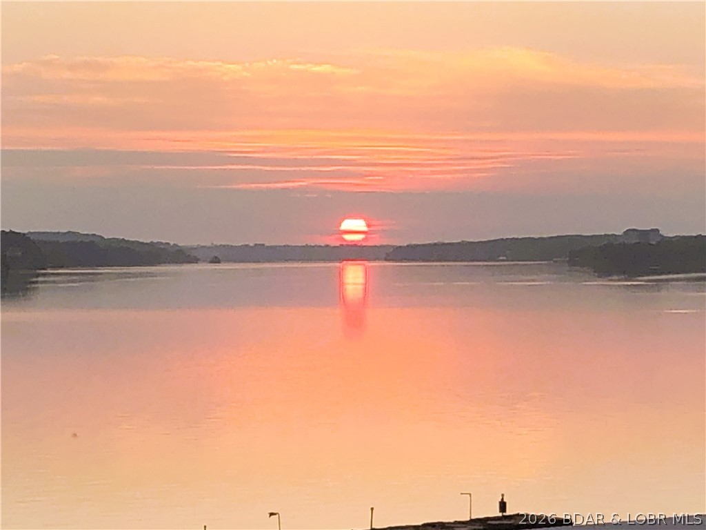 Wake up to stunning lake views in this beautiful 4-bedroom 3-full bath condo at the Lake of the Ozarks. Designed with comfort and entertaining in mind, the open living area flows seamlessly to a private balcony overlooking the water-perfect for morning coffee or sunset evenings. The spacious layout provides plenty of room for family and guests, while the community offers wonderful amenities that includes, pool, clubhouse, game room, tennis and more! Whether you're looking for a weekend escape or full-time residency, this lakefront condo delivers the ultimate Lake of the Ozarks lifestyle. Included is a 12x28 boat slip!! Seller willing to assist with HOA dues with the right offer!!
