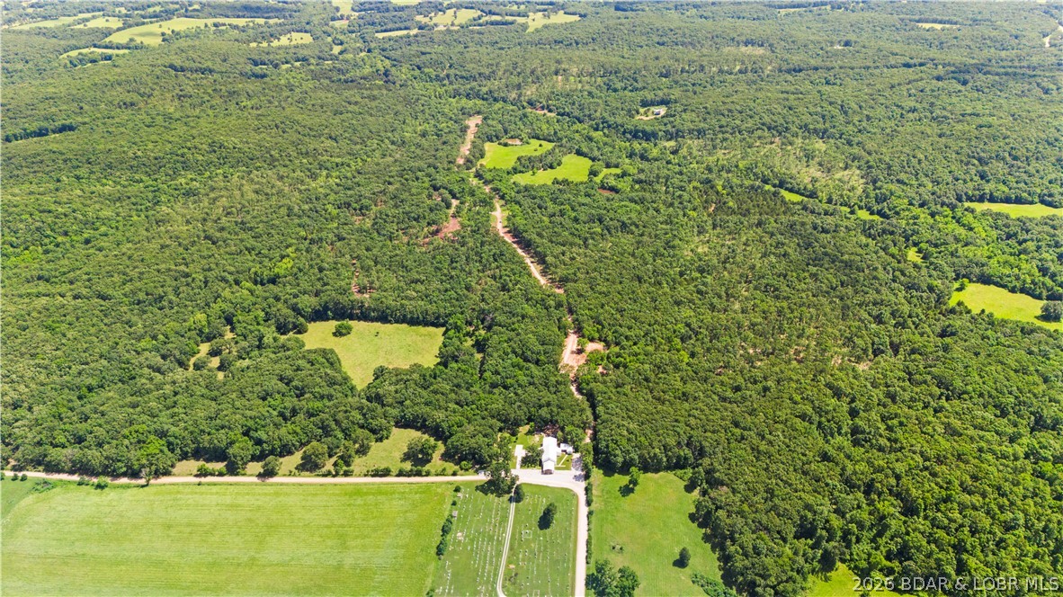 Tucked away just 4/10 of a mile off Highway 52, this exceptional 9.48-acre property offers the perfect blend of accessibility, privacy, and freedom. Situated near Big Rock Road directly behind the church and featuring a newly constructed access road, the land boasts a highly desirable level-to-moderate terrain that is ready for your vision. Best of all, there is no HOA to restrict your plans, giving you complete control over your estate. Enjoy the peace and quiet of a secluded rural setting while remaining just a convenient 10-minute drive from the heart of Eldon.