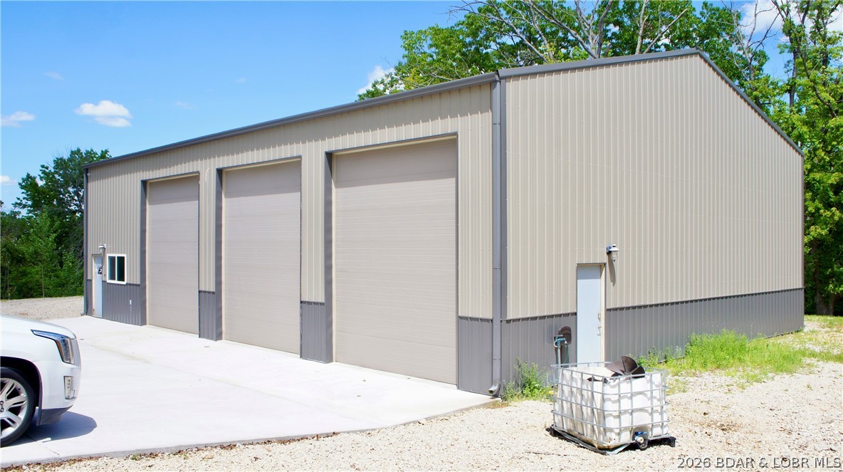 Incredible opportunity for a small business, or manufacturing facility.  This building has 3240 Square ft including an office and a bathroom.  There are two door cuts for an expansion of another 30x60 building to attach.  The concrete floor is heated along with a forced air and heat system. This includes a screw type compressor with all the lines in th walls throughout. A 400 Amp service to run most heavy equipment. The lot can accommodate 30 or more cars, plenty for a business or storage for equipment.  Location is prime, just outside of Osage Beach with great traffic for visibility.  Don't miss out on this one.