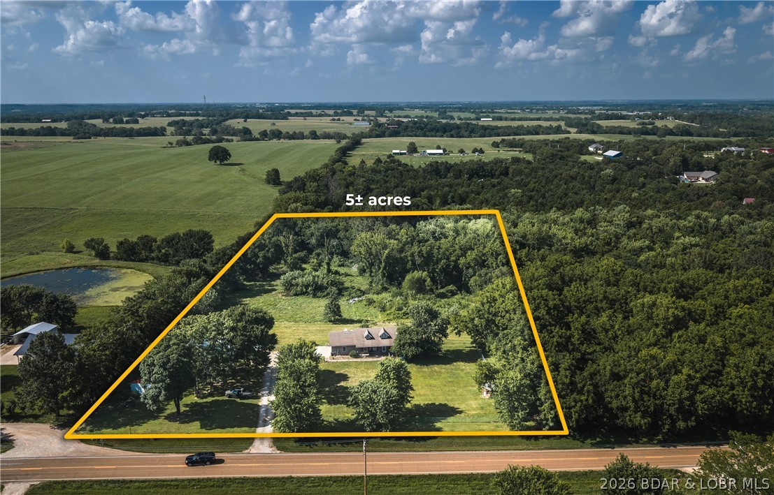 Opportunity is knocking! Bring your vision and transform this unique nearly 5-acre property into something special. Featuring two homes, a detached garage/shop, private well and septic, and desirable Highway Y frontage, this property offers endless potential for investors, renovators, multi-generational living, rental income, or a homestead project. The main home offers approximately 5 bedrooms, 2.5 baths, and an attached garage, while the second residence includes a studio-style 1-bedroom, 1-bath layout perfect for guests, extended family, or future rental possibilities. Property is being sold STRICTLY AS-IS. Extensive repairs are needed throughout, including significant sheetrock damage. Roof leaks are present. Well water contains iron deposits causing rust-colored staining on fixtures. HVAC condition is unknown, as it has not been operated by the owner for several years. Buyers should perform all inspections and verify all information to their satisfaction. If you're looking for a project with acreage, multiple buildings, and room to build equity, this is one worth seeing.