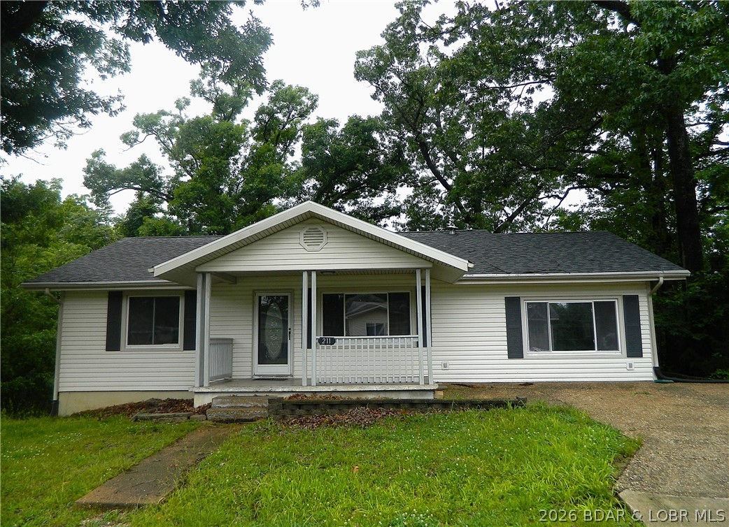 Perfect for first-time homebuyers or savvy investors! Nestled just off the vibrant Bagnell Dam Strip, this charming home features 3 bedrooms and 2 full baths. The main level boasts a spacious kitchen and living area, plus a versatile bonus room ideal for a dining space, home office, or cozy sitting room. Convenience is key with main-level laundry and seamless access to the back deck right off the kitchen. The finished lower level expands your living space with a family room, utility room, and an additional bedroom and full bath with its own exterior exit under the deck. New Roof in 2025. Bonus: An additional lot is included, offering plenty of room to build your dream garage or shop!