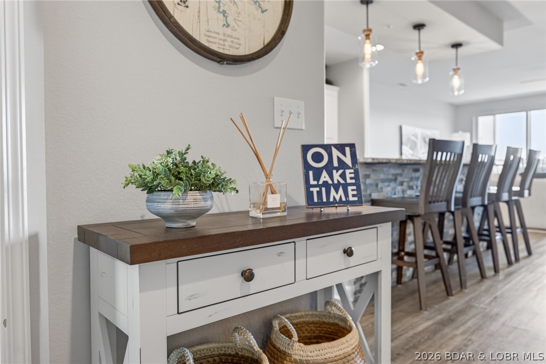 Beautifully updated, thoughtfully designed, and perfectly positioned to capture sweeping views of the 1 MM Gravois Arm, this Blue Anchor Bay condo is the complete package! The bright, open layout, elevated finishes, and seamless blend of comfort and style makes this unit feel more like a lake home than a condo. The stunning kitchen features abundant cabinetry, granite countertops, a large island with seating. Natural light pours through the lakeside windows with breathtaking views and create an inviting atmosphere throughout the open living space, complete with the electric fireplace and designer-inspired touches. The primary suite offers a walk-in closet and beautifully updated bathroom, while the screened deck serves as an outdoor living room. Elevator access makes coming and going easy, and the included 12x32 boat slip puts endless days on the water right at your fingertips. One of the lake's most sought-after communities, offering two swimming pools, swim platforms, kayak launch, gym, playground, pickleball and basketball courts, fish cleaning station, and a waterfront boardwalk. No rentals allowed, creating a peaceful, owner-focused atmosphere.