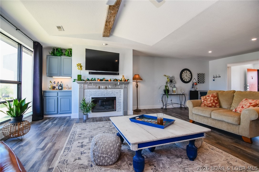Enjoy the ultimate retreat with this TOP FLOOR 3-bedroom, 2.5-bath fully furnished condo at Osage Vistas! This spacious condo has SUPER LAKE VIEWS, is move-in ready & loaded with updates, including newer vinyl plank flooring, fresh paint, stainless steel appliances, garbage disposal, stack washer and dryer, and a new HVAC system installed in 2024 with a 5-year warranty. The open floor plan and beautifully decorated interior create the perfect space for relaxing weekends at the lake or full-time living. Cozy up by the electric fireplace on cool evenings, then spend your summer days enjoying the pool located right across the street, plus access to 5 additional pools and Four Seasons amenities. Outdoor lovers will appreciate the abundant green space, walking and running areas, picnic tables, BBQ areas, and nearby state parks ready for exploring. The deeded carport keeps your vehicle protected year-round, and the location is hard to beat — just minutes from the famous Bagnell Dam Strip, theaters, shopping, restaurants, grocery stores, and more. Whether you're searching for the perfect vacation escape, investment property, or full-time lake lifestyle, this condo checks all the boxes.