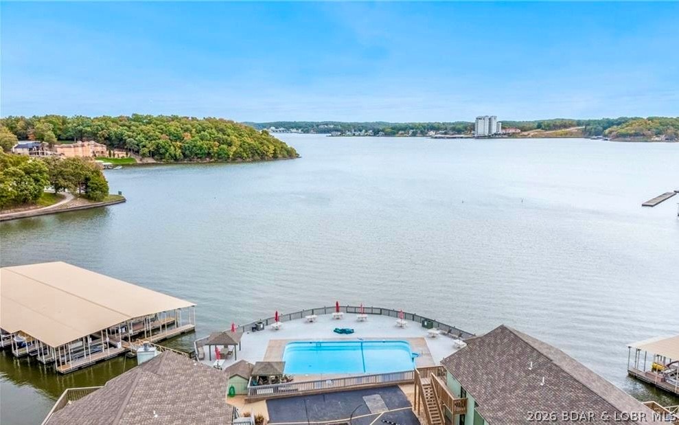 Beautifully updated TURNKEY lakefront condo at Southwood Shores with breathtaking morning sunrise lake views! Located just 3 buildings from the lakefront pool, this move-in-ready retreat includes a 10x24 boat slip with 6,000 lb lift and is only one short flight of steps from parking level. The remodeled kitchen features all-new cabinetry, countertops, center island, tile flooring, stainless refrigerator, and updated flooring throughout. Additional upgrades include a new washer/dryer, all new furnishings, patio set, and gas grill. Both bedrooms offer new carpet and furnishings, while the bathrooms feature updated vanities and lighting. Tucked in a quiet cove, the private deck is the perfect place to relax and enjoy the peaceful waterfront setting. The homeowners spared no expense and poured exceptional care into every detail. Southwood Shores offers year-round amenities including a lakefront pool, newly renovated indoor heated pool, hot tub, concrete boat ramp, trailer parking, swim dock, playground, tennis/pickleball courts, and gated community. PWC Slip available for purchase and 2013 Bennington 24’ with Mercury 150 (325 hours, excellent condition) is also available for purchase.