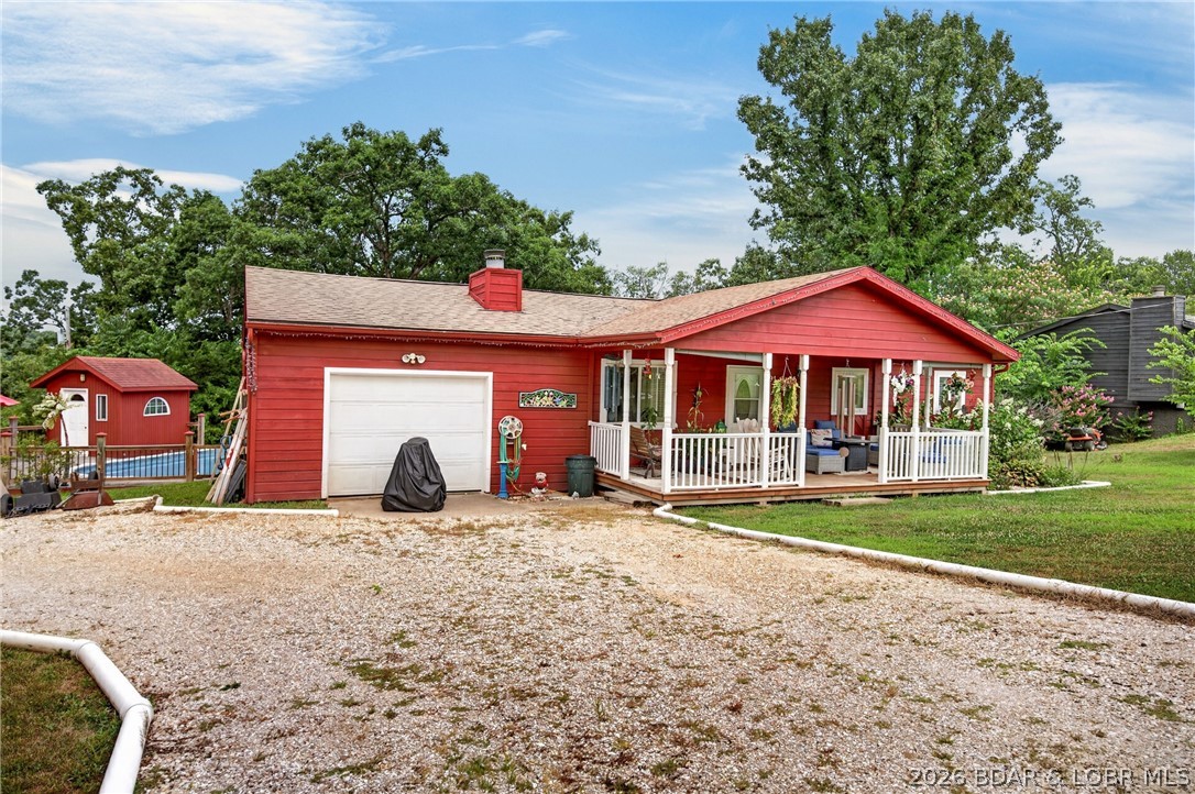 Perfectly positioned between Camdenton and Osage Beach just off highly desirable A-Road, this all one-level home offers the convenience today’s buyers are searching for! Whether you’re a first-time buyer, looking to downsize, or searching for a solid investment property, this home checks all the boxes. Featuring 2 bedrooms, 2 full baths, a half bath, and an attached 1-car garage, the open-concept layout showcases vaulted ceilings, a cozy fireplace, and spacious living, dining, and kitchen areas ideal for everyday living and entertaining. Recent updates include a 2-year-old HVAC system, laminate flooring throughout the living room, hallway, and bedrooms, tile flooring in the entry, kitchen, baths, and laundry, plus updated bathrooms with newer vanities and glass shower doors. Outside, enjoy a level yard with mature landscaping, rock garden, storage shed, pool house, and an above-ground pool surrounded by a large deck—perfect for summer fun. Relax on the covered front porch or unwind under the retractable awning on the back deck. Affordable homes in this location under $250,000 are becoming increasingly rare—don’t miss this opportunity!