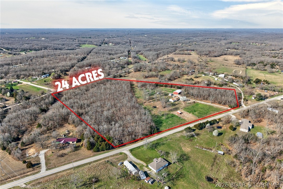 Great 24-acre hobby farm on Hwy WW in Lebanon with blacktop access to a gated entrance! This mini farm offers a great mix of open pasture and woods, making it ideal for livestock, horses, or hunting. The property is fully set up with multiple outbuildings, including a 30x60 barn with three 10x20 stalls, tack room, 10x20 lean-to for hay, tons of storage, full electric, and a bathroom (water line from house to barn needs replaced). Also included are a 55-ft corral with river sand footing, 14 fruit trees including apple, peach, pear, and crabapple, two duck coops, an 18-bird chicken coop, and a 3-ton feeder. Fenced and cross-fenced for cattle, goats, and horses.
The 3-bedroom, 2-bath home offers approximately 1,800 sq ft with a large kitchen, abundant cabinetry, center island, spacious mud/laundry room with sink, living room with coffered ceilings and gas fireplace, plus a dining/den area. A covered wraparound porch, back deck, and classic dormers complete the package. If you’ve been looking for manageable acreage with easy highway access and everything in place, this one is ready to go.