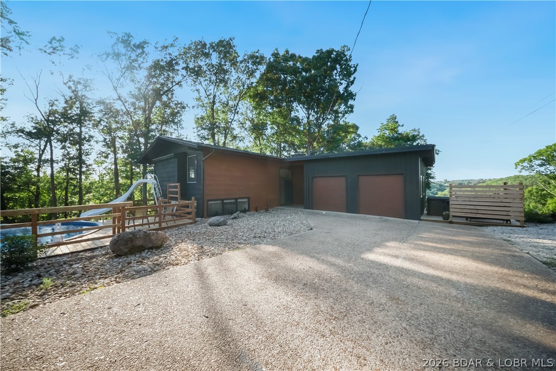 Must see fully remodeled home on 13 acres with POOL/HOT TUB and SHE SHED !   Located in the highly sought-after Panoramic Subdivision-a prime IN-TOWN location in Camdenton.  Minutes from all local amenities you can not beat this location!! The home features  upper level huge master bedroom, kitchen with skylight, adjoining spacious open dining and living room with fireplace.   Lower level includes 3 bedrooms, bath, and family room with air-tight wood burning stove.  Sliding glass doors on both levels lead to oversized decks.  Garage is oversized with separate work shop/storage area.  Take a dip in the pool,  relax in the hot tub or bow hunt & hike on 13 acres of mature timber in your back yard!  She shed is included  but can not be used as a dwelling.
  Will not last long at this price!