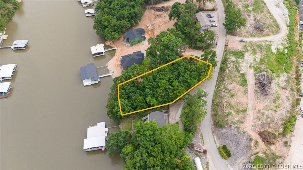 Build the luxury lakefront home of your dreams in this exciting new upscale subdivision! Lot 5 offers 111 feet of shoreline and 128 feet of road frontage, providing an exceptional setting for a custom waterfront retreat. Enjoy breathtaking main channel views combined with the benefits of cove protection, creating the perfect balance of scenic beauty and functionality. With plenty of space to design and build your ideal home, this premier homesite is a rare opportunity in a highly desirable location. Best of all, there is NO HOA, giving you the freedom and flexibility to make your vision a reality. Call for a private showing today!