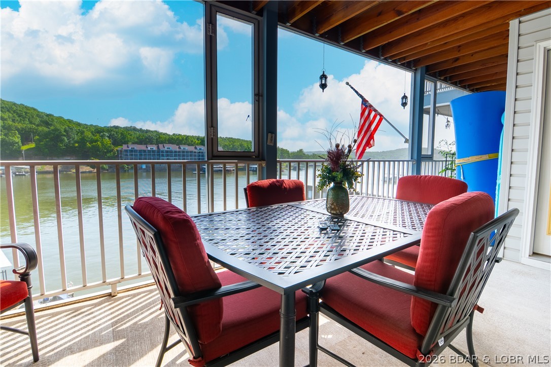 Don't miss your opportunity to own a beautifully furnished waterfront condo at Vision Condominiums on the 5 MM of the Niangua Arm at Lake of the Ozarks! With four units sold in the last three months, these sought-after condos don't stay available for long. This 1,150 sq. ft. condo features 2 bedrooms, 2 bathrooms, and luxury vinyl plank flooring throughout. It's being sold furnished, with only a few personal items excluded, making it move-in ready. Relax on the screened-in deck complete with a TV and a 6-person dining set, perfect for outdoor entertaining. The unit also includes a 12x30 boat slip with a 10,000-lb lift. Vision Condominiums offers a heated community pool, onsite management, and meticulously maintained grounds. Enjoy the peace of a renter-free community with no Airbnb or vacation rentals, plus convenient open parking. Whether you're looking for a full-time residence or a lake getaway, this is your chance to own in one of the lake's most desirable waterfront communities.
