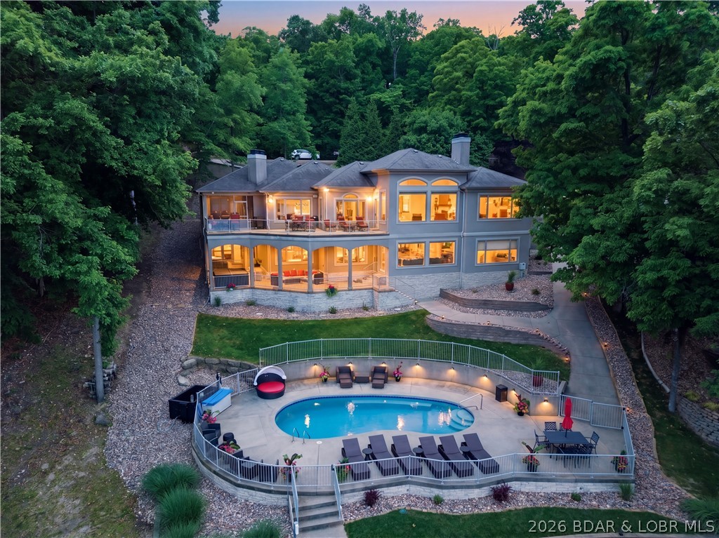 RARE OPPORTUNITY! Coming soon, the seller is adding a private pickleball court on the adjacent lot, creating one of the Lake’s most unique lakefront properties with an amenity rarely found at a private residence, especially on the water. Wake up to sweeping channel views and end your evenings surrounded by privacy in this updated Thomas Construction home, perfectly positioned on nearly an acre with 168’ of lakefront in one of the Lake’s most sought after locations. Completely updated in 2023, this 5 bedroom, 4.5 bath home was designed for luxury living and entertaining with only 2 levels instead of 3, allowing for large gathering spaces throughout. Quality craftsmanship shines from the soaring 16’ ceilings and trim work to the hickory engineered hardwood floors, four fireplaces throughout the home including one on the screened porch, and a gourmet kitchen featuring custom knotty alder cabinetry and high end appliances. The spacious primary suite offers a spa inspired bath with copper soaking tub, oversized walk in closet, and laundry access. The lower level features a full bar and second laundry area, perfect for hosting guests. Outside, enjoy the new 2 slip dock and pool too.