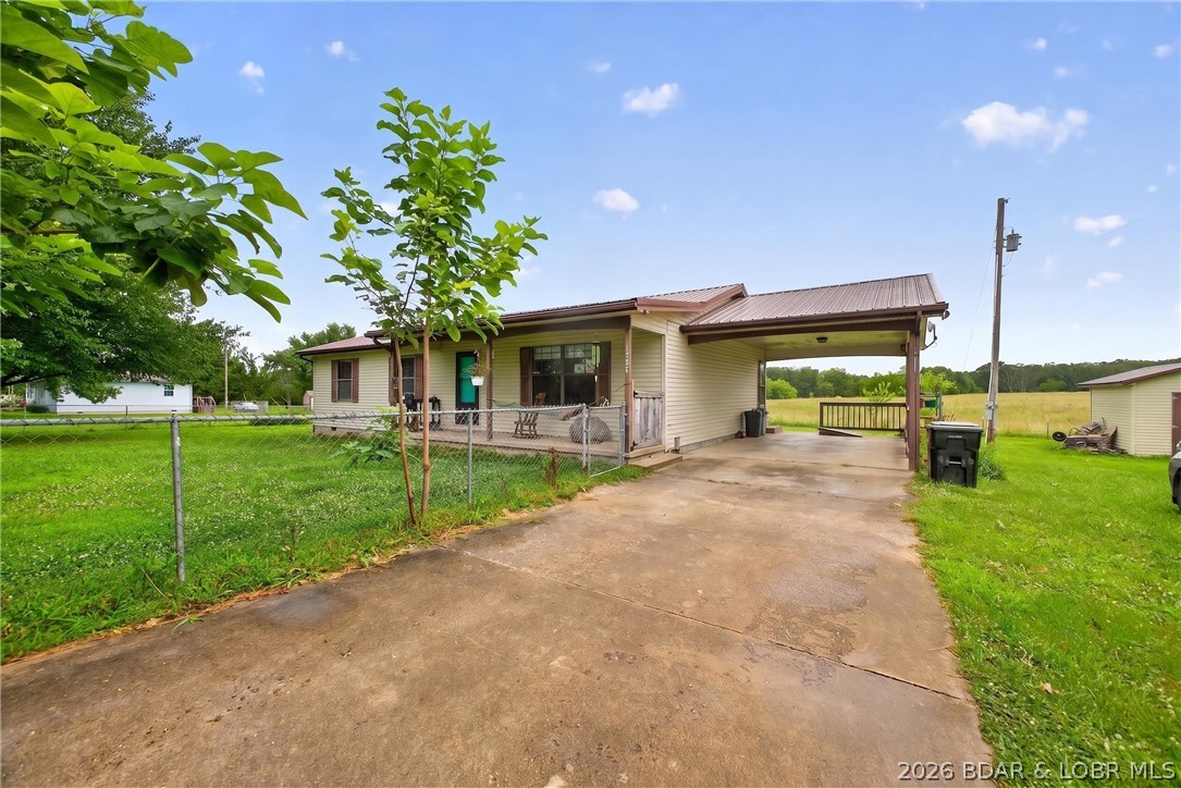 Stop renting and start owning!! Welcome to this 3BR/1.5BA ranch-style home in a serene country setting and town convenience. Designed for functional main-level living the layout features a primary bedroom with a half bath, dining area, a welcoming living-room, hall full bathroom, 2 more bedrooms and a generous laundry room. Move in ready new luxury vinyl flooring has been installed throughout the home & no worries a new septic has also been installed. Situated massive, level lot with a fenced in front  yard perfect for your pets or small children. Carport and great parking. The existing carport offers a fantastic opportunity for a garage conversion to add instant equity. Plenty of room for your own garden & storage shed in the back for all your gardening tools. Whether you are a first-time buyer, looking to downsize for retirement or an investor searching for a solid rental, this affordable gem fits the bill. This affordable home won't last long—book your showing today!