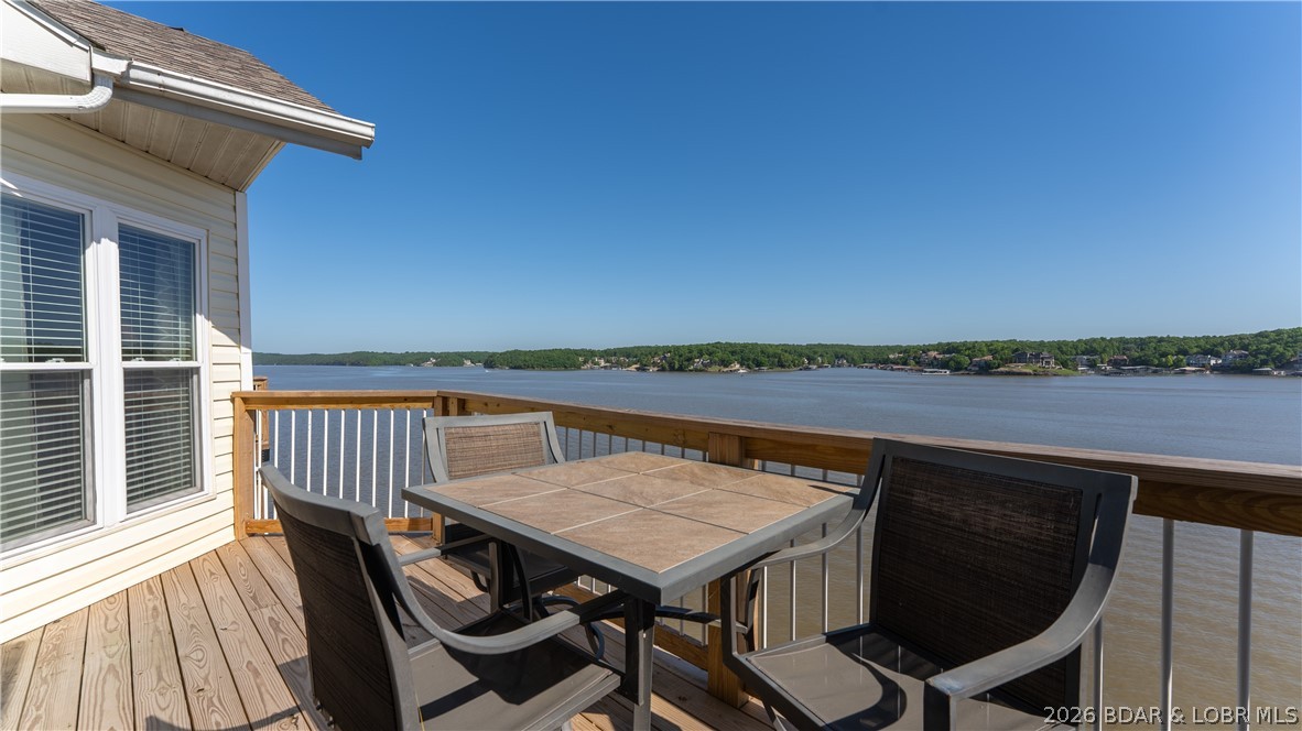 Experience breathtaking panoramic main channel views from this top-floor condo at The Ledges in the heart of Osage Beach. This fully turnkey opportunity includes a proven rental history, a 14x40 boat slip, and a PWC slip—offering the perfect blend of lake lifestyle and investment potential. Located in Building 9, this updated unit features vaulted ceilings, an expansive wall of windows, a brand-new deck, and spacious living areas designed for relaxing and entertaining. The oversized loft-style third bedroom offers incredible flexibility for additional guests and sleeping space, while the lakeside primary suite features private deck access, stunning views, a walk-in closet, and double vanity sinks.  The Ledges offers resort-style amenities including two pools, a swimming beach, and an unbeatable 21MM location with quick access to waterfront restaurants, shopping, entertainment, and more by land or water. Whether you’re searching for a lakefront getaway, full-time retreat, or investment property, this condo checks all the boxes with top-floor privacy, incredible views, a sought-after dock package, and one of the best locations at Lake of the Ozarks.