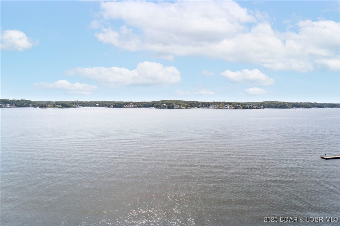 One of the most beautiful condos at the lake! Remodeled in 2018, this lovely penthouse condo has been gently used due to traveling owners that have the countryside to see! The most desirable floor plan at Palisades, you'll find it spacious with the most spectacular eagle's view that goes for miles. A major renovation took place in 2018: New luxury vinyl flooring, kitchen appliances, painted throughout, lowered bar height counter top and added Cambria Quartz counter tops that are absolutely gorgeous! New reverse osmosis drinking water, new bar with wine cooler, new lakeside Hunter Douglas blinds, new light fixtures and living room fan. Additional attic insulation was added and a new heat pump installed in 2020. 16 X 32 boat slip included and the closest designated parking space there is. Garage directly in front of condo is available to purchase as well as a 15,000 lb boat lift and 290 open bow SeaRay for sale with twin 6.2 engines. Ultimate condo package in the best location there is at the Lake of the Ozarks! Only minutes from town and centrally located at the 14.5 mile marker by water. Just bring your toothbrush and the family and enjoy this wonderful get-a-way.