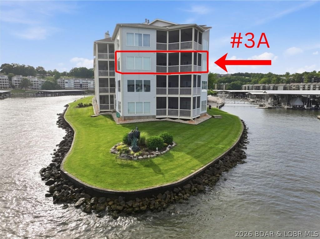 Enjoy breathtaking lake views from this spacious 2,900+ sq. ft. condo on the 12-mile marker of Lake of the Ozarks. Featuring 3 bedrooms and 3.5 baths, this home offers 10-foot ceilings with crown molding throughout, creating an open and elegant feel.
The spacious great room includes a wet bar and fireplace, making it perfect for entertaining, while the screened deck provides the ideal place to relax and enjoy the lake. The primary suite features abundant windows, allowing you to wake up each morning to stunning water views. With easy access to the community dock and an eastern exposure for spectacular sunrises, this condo offers the perfect blend of luxury, comfort, and lakefront living.