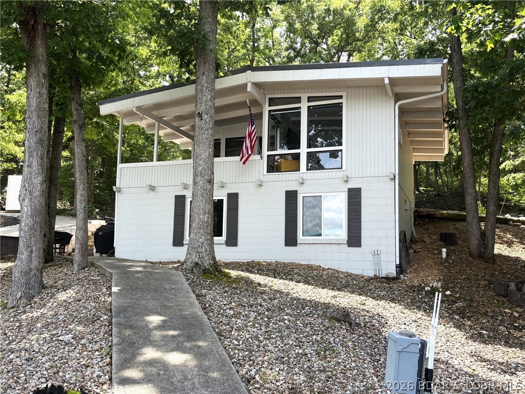 Sitting on a gentle lot in a beautiful cove location, this gem offers everything you need for summer fun at the lake. The walk in level offers the kitchen, dining area, living room, bedroom and 1/2 bath, along with a wonderful covered deck that has the best views.
The separate lower level holds an additional bedroom, full bath, a sitting area and ample storage area that holds potential for expansion.  The cove location is ideal and offers great views.  Several updates over recent years are new metal roof, flooring, paint and mini split.   If you are looking for your start at the lake, you need to see this one.  It's all that lake fun was meant to be! Fully furnished and just waiting for you,