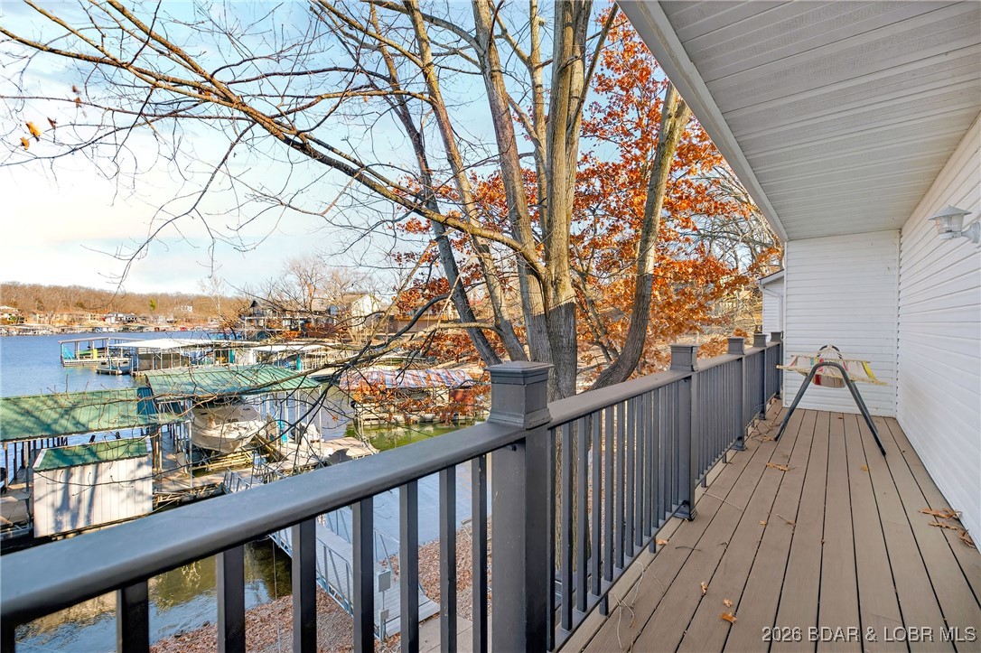 Lake life doesn’t get easier—or cozier—than this. This two-story condo offers the comfort of a home with the simplicity of condo living, perfectly suited for year-round enjoyment. With 0 steps from the parking lot to the front door and just 8 steps to the lake, convenience is built right in. The main level features 3 bedrooms and a full bath, including a private primary suite with its own wood-burning fireplace—an ideal retreat on crisp fall evenings. The lower level is designed for gathering, with an open kitchen, welcoming living space highlighted by a second wood-burning fireplace, a utility/storage room, and an additional full bath with walk-in shower. Thoughtful updates include waterproof vinyl plank flooring, refreshed bathrooms, and a low-maintenance composite deck. Offered fully furnished and move-in ready, this condo also includes access to a four-slip dock with a 12x30 boat slip and a shared rooftop patio showcasing panoramic lake views. With only four condos in the complex, low assessment fees, and ample parking for vehicles and boat trailers, this is a rare opportunity for stress-free lakefront living—whether you’re enjoying warm summer days or cozy Ozark fall nights.