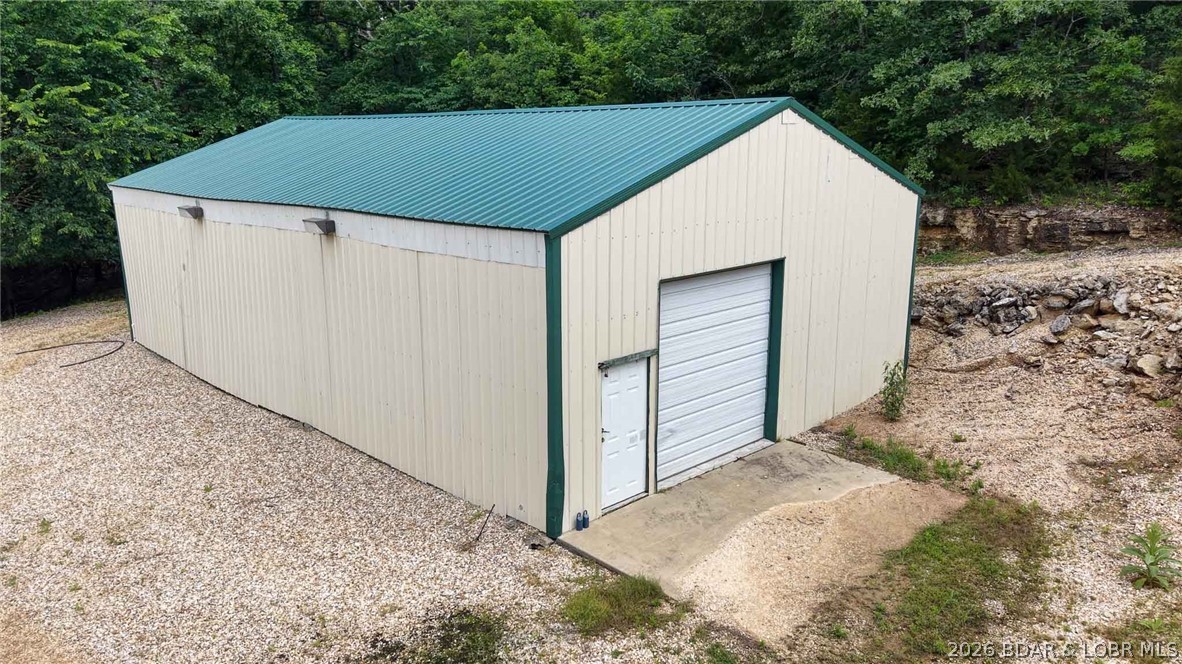 Rare opportunity to own approximately 1 acre with 150 feet of Lake of the Ozarks shoreline at the 66 Mile Marker! This unique waterfront property features a versatile 30' x 52' metal building with concrete floors, heating and air conditioning, sewer plumbing in place, and a garage door for easy access. Currently serving as a game room, the building offers endless possibilities—convert it into a workshop, storage facility, shouse, barndominium, or your custom lakefront retreat. With ample space to expand and exceptional lake frontage, this property is the perfect canvas for your vision. Enjoy beautiful lake views, easy water access, and the peaceful setting of one of Lake of the Ozarks' most desirable areas. Bring your ideas and start creating your dream lake property today!